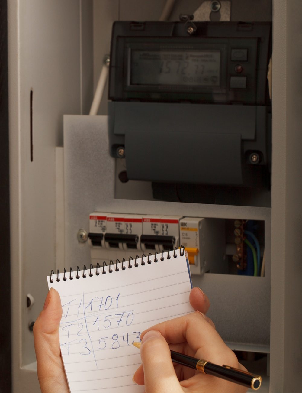 Rewriting of the electrical meter readings at home in Russia. Close up shot.