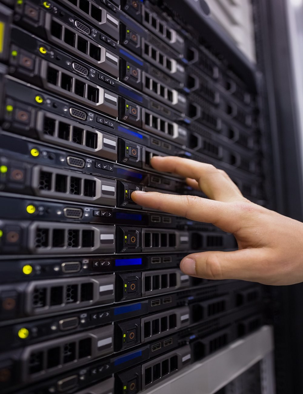 Technician working on server tower in large data center